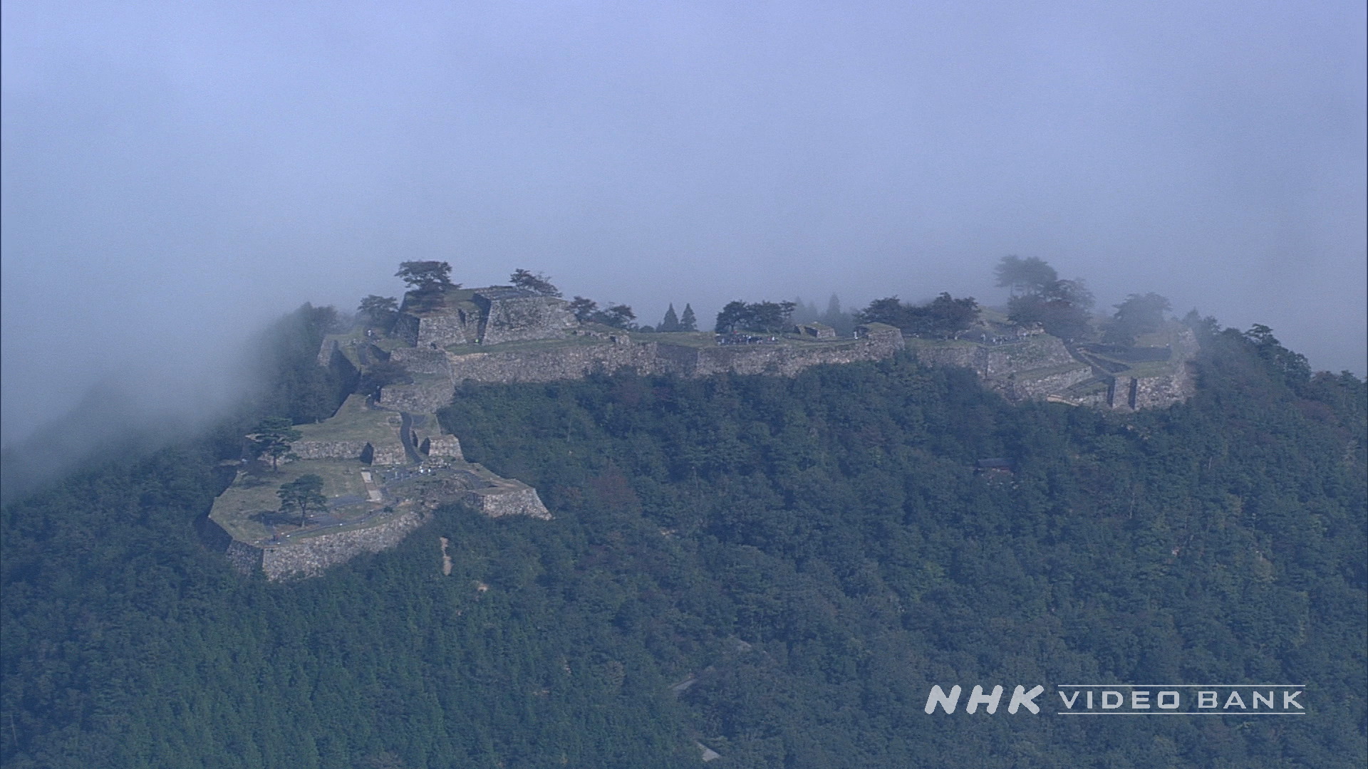 Aerial: a medieval castle shrouded by stunning morning mist